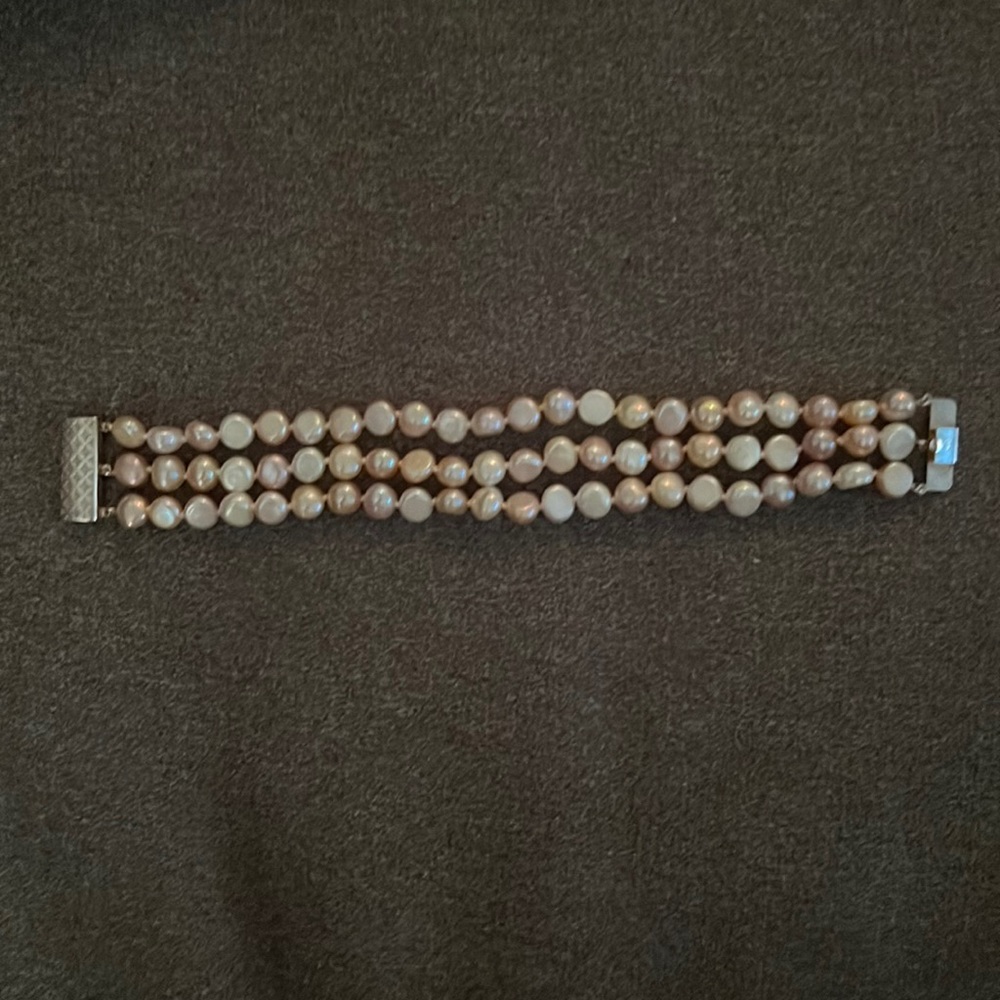 Three-strand multi-color fresh water pearl bracelet with sterling silver clasp.